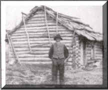 Andrew Peterson outside his log cabin