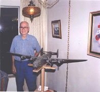 Ray with B-24 in their living room sent by Mrs. Janice Johnson Green.