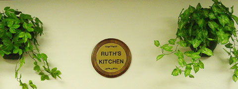 This plaque is hanging over the serving counter of the kitchen